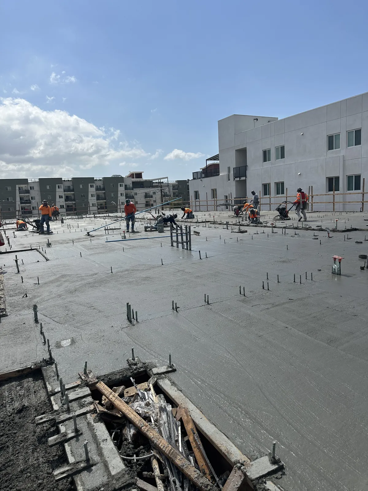Crew finishing a freshly poured commercial elevated deck