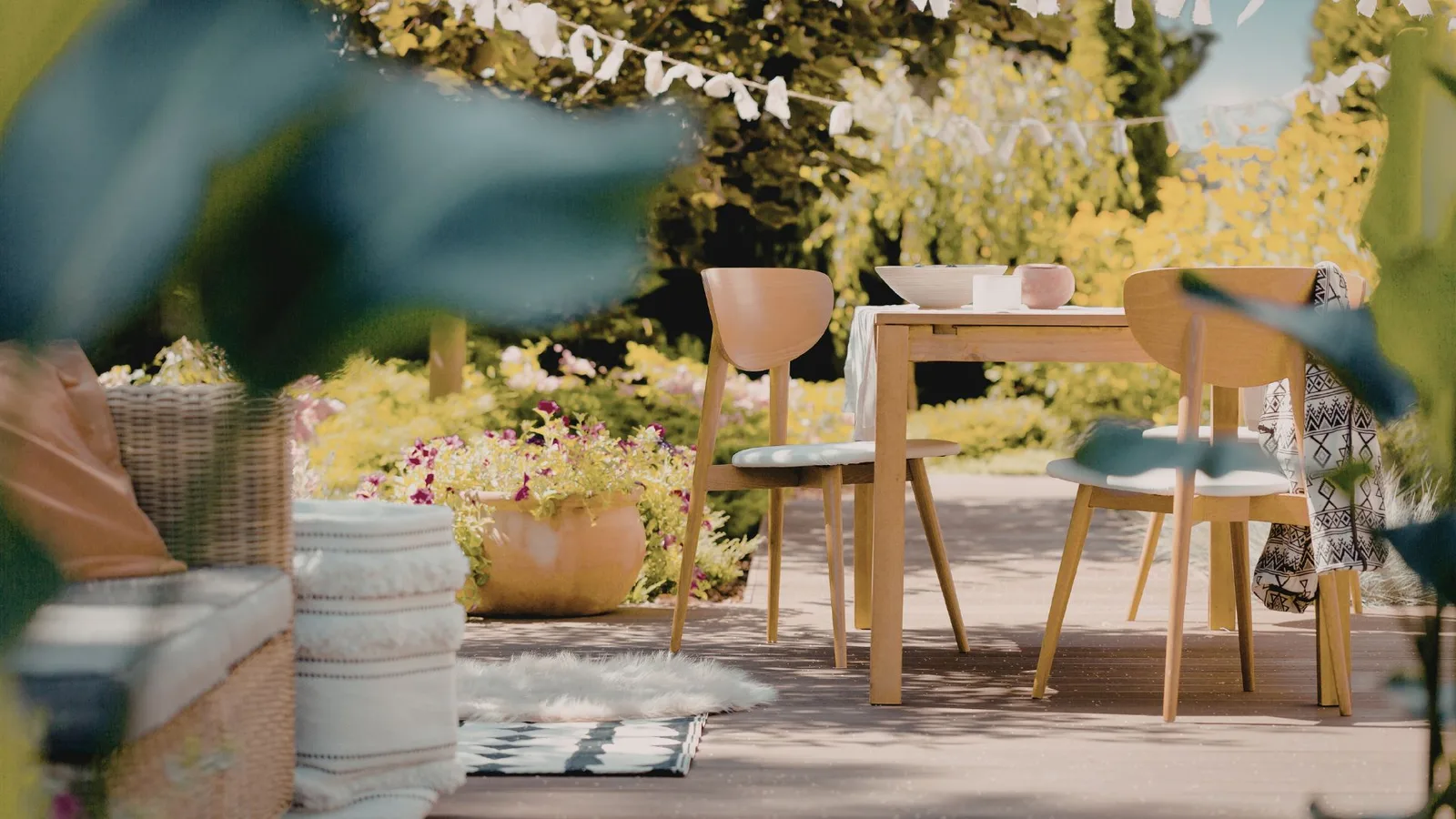 Backyard residential patio with table, chairs, and surrounding garden