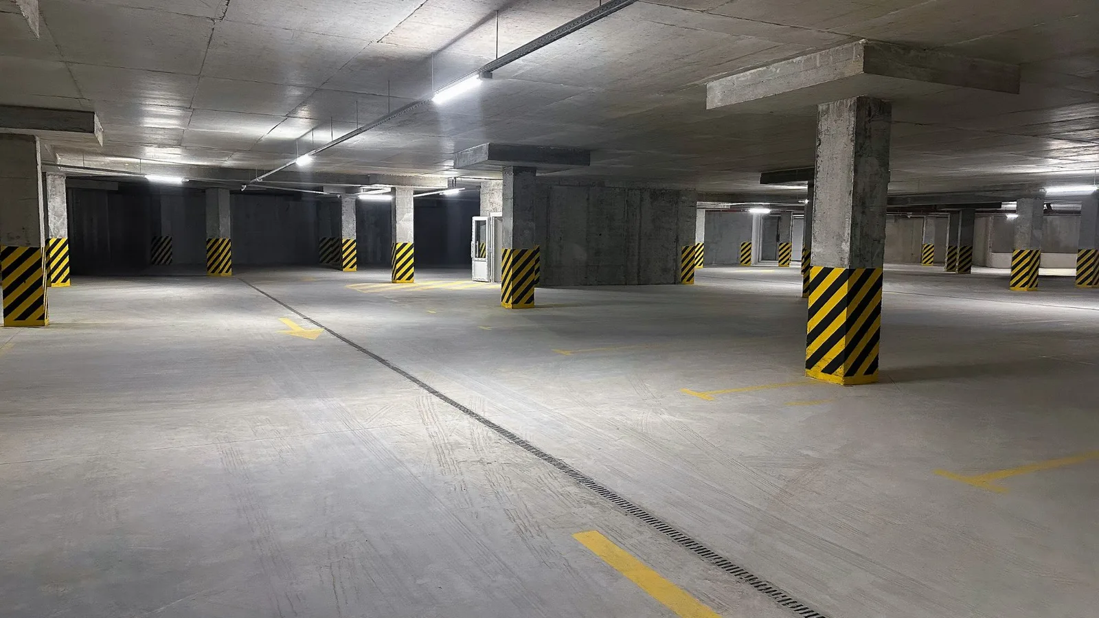 Subterranean concrete parking garage with columns and lane markings